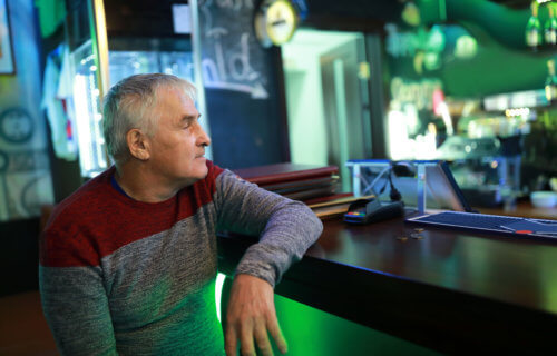 Older man, baby boomer, alone at bar