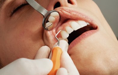 Dentist patient having teeth and gums examined