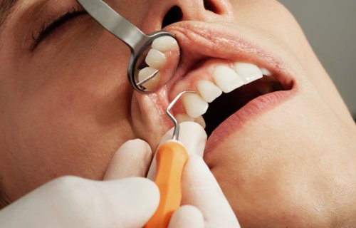 Dentist patient having teeth and gums examined