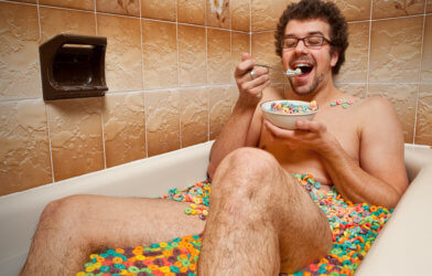 Man eating cereal in bathtub