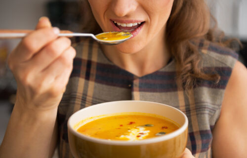 Woman eating soup