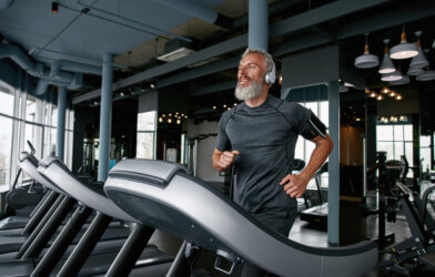 Older man jogging and running on treadmill