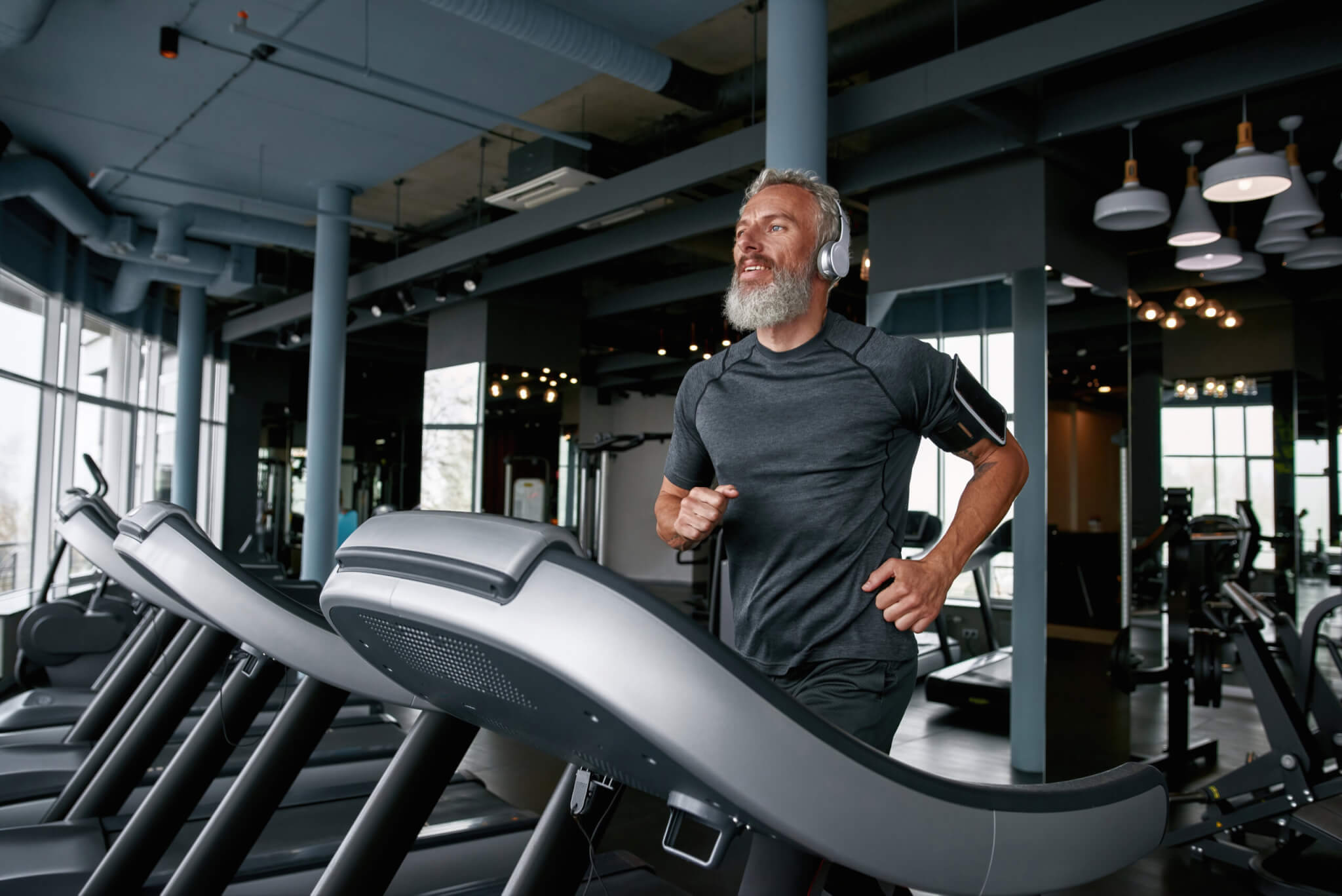 Older man jogging and running on treadmill