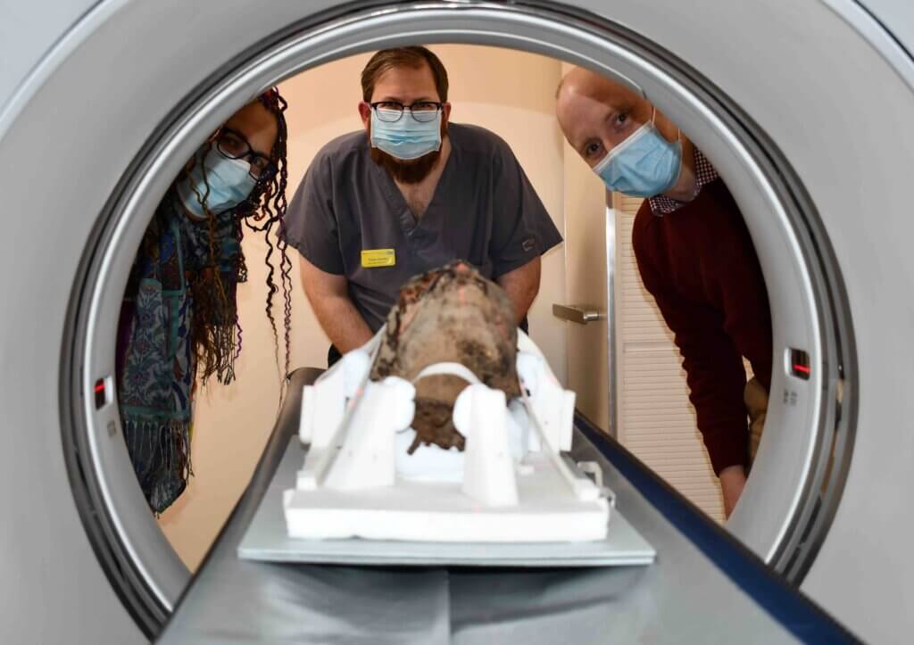 Decapitated Egyptian Mummy head being placed into CT Scanner