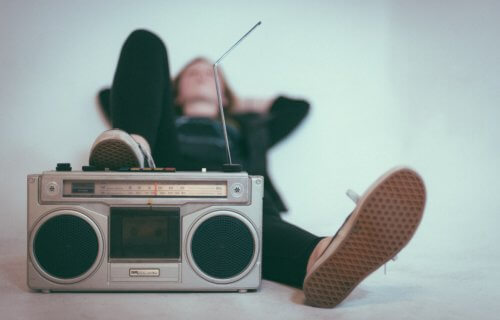 Child or teen listening to music on a boom box