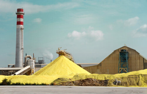 Sulfur Factory / A Yellow Pile of Sulfur Produced in an Industrial Facility