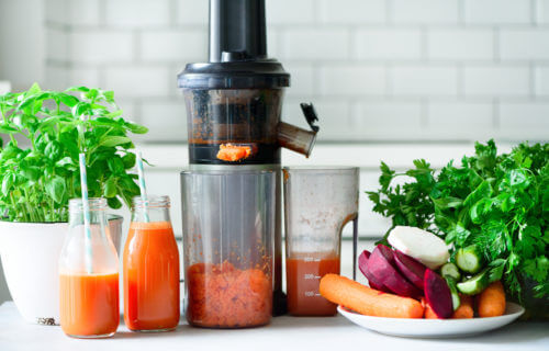 Juicer being used to make fresh fruit and vegetable juice