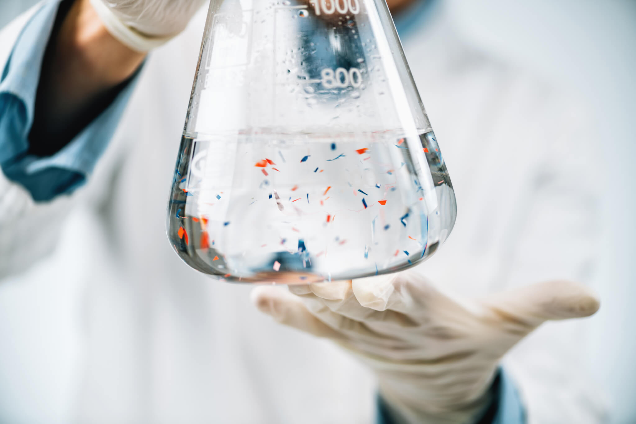 Microplastics in beaker filled with water