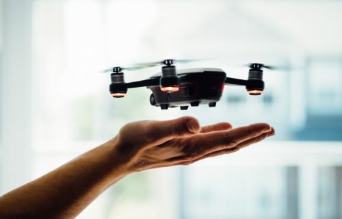 Drone camera hovering above a person's hand