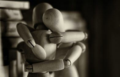 Wooden figures hugging