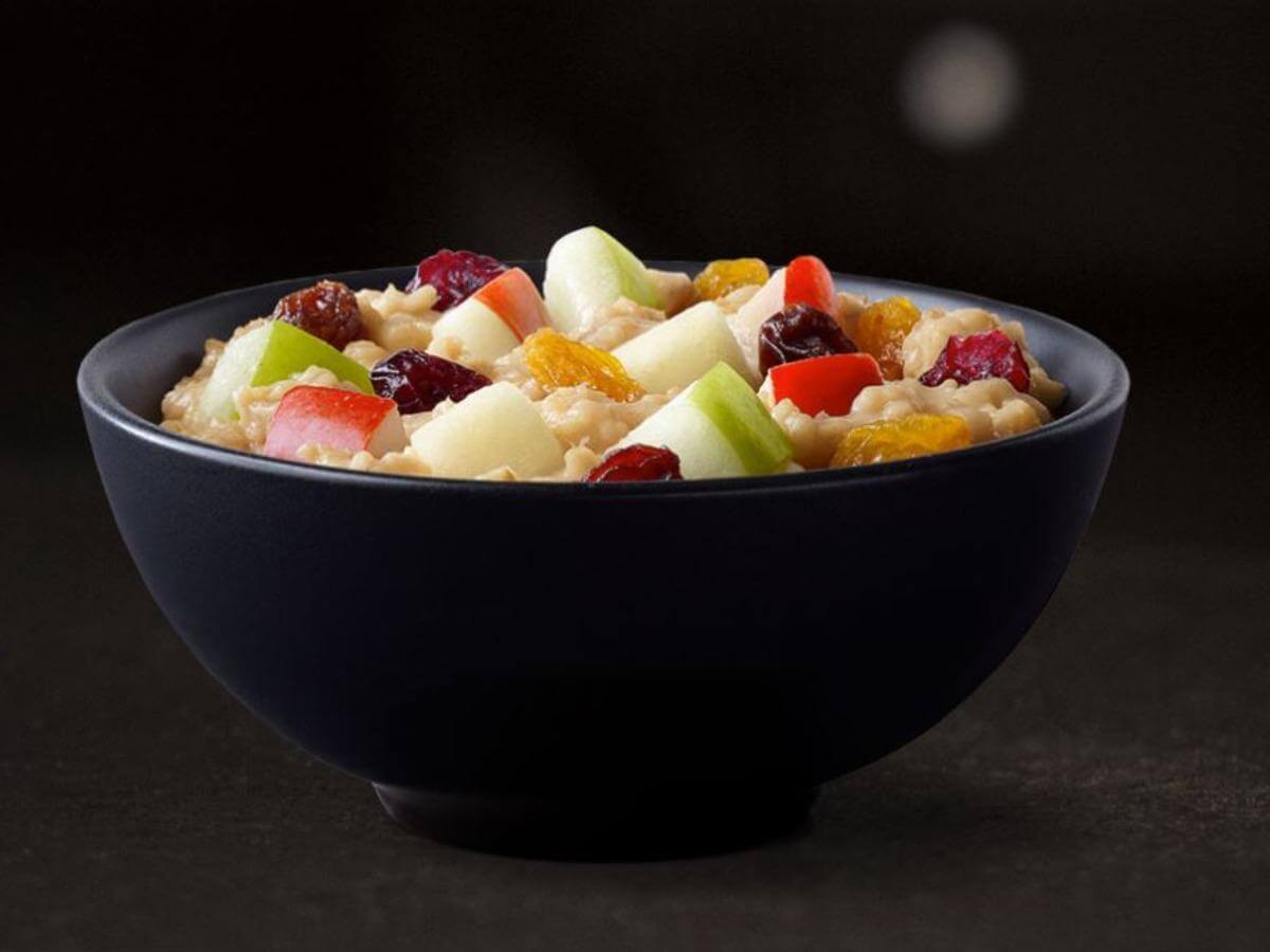 black bowl of oatmeal with fruit