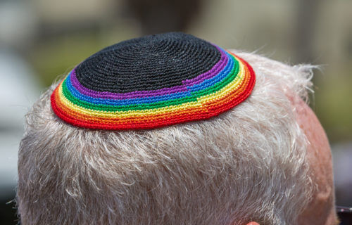 LGBT pride parade Tel Aviv, Israel: Jewish person wearing rainbow yarmulke.