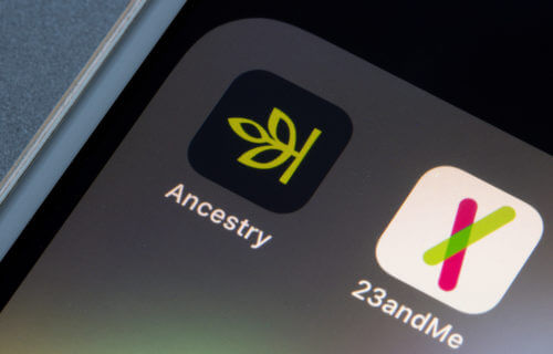 Ancestry and 23andMe DNA Kit apps on smartphone