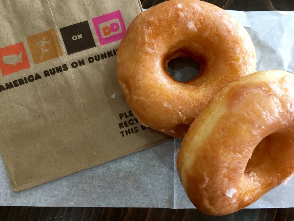 glazed donut with dunkin donuts bag