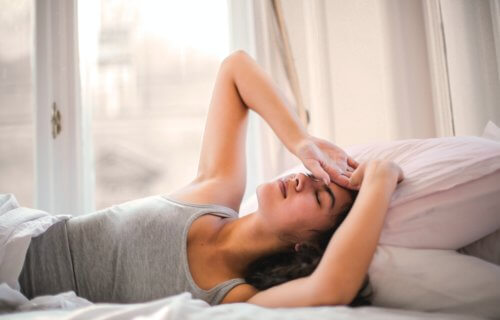 Tired woman in bed struggling to sleep