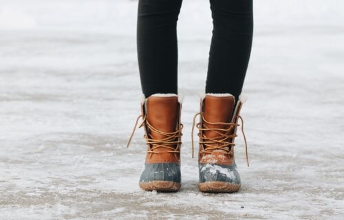 Woman wearing warm boots in the snow