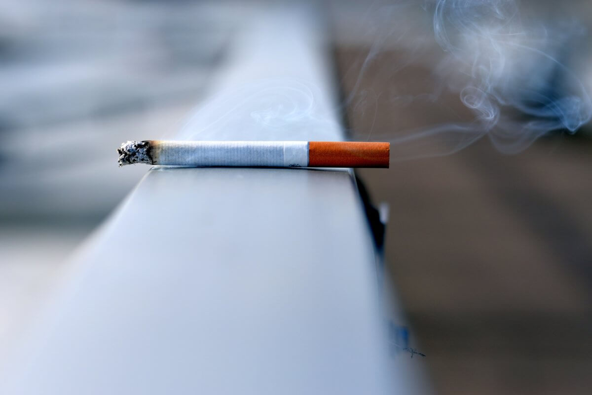 Lit cigarette burning on a ledge