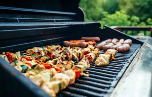 Barbecue chicken, hot dogs and burgers on the grill.
