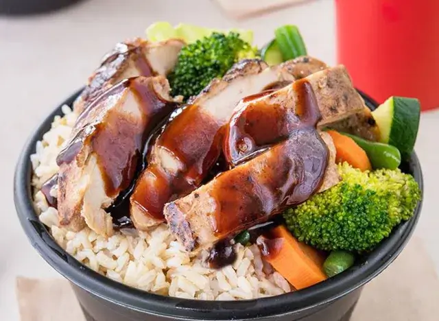 Bowl with teriyaki chicken, brown rice, carrots, and broccoli