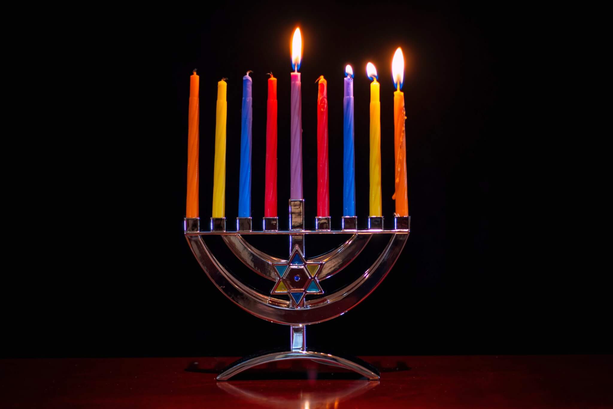 Hanukkah menorah with colorful candles.