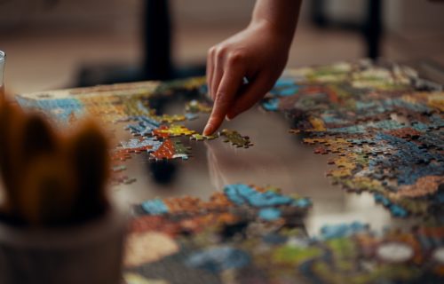 Person working on a jigsaw puzzle