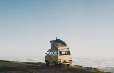 Van life: Nomads with van parked in front of ocean