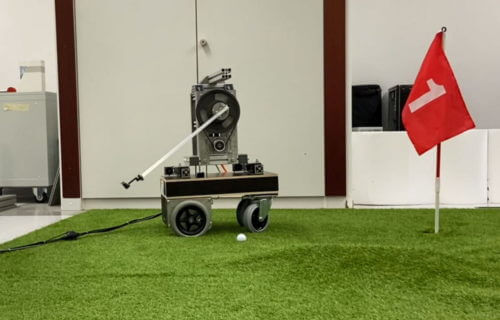Golfi the robot making a putt.