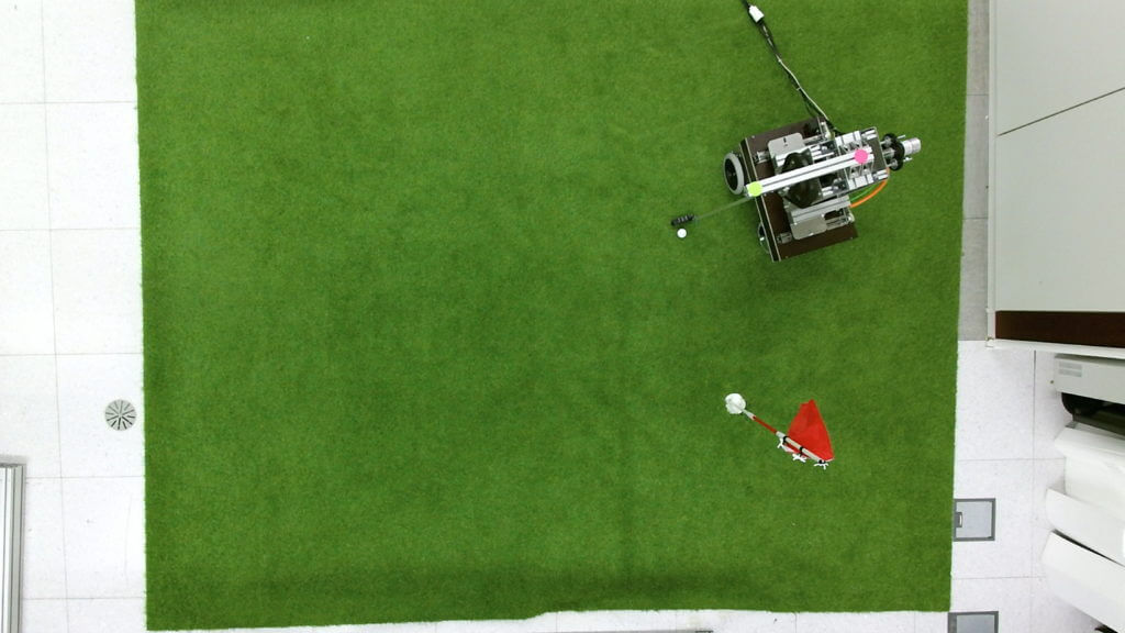 Golfi the robot sinks a putt.