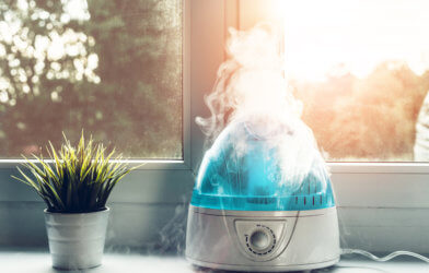 Air humidifier during work. The white humidifier moistens dry air