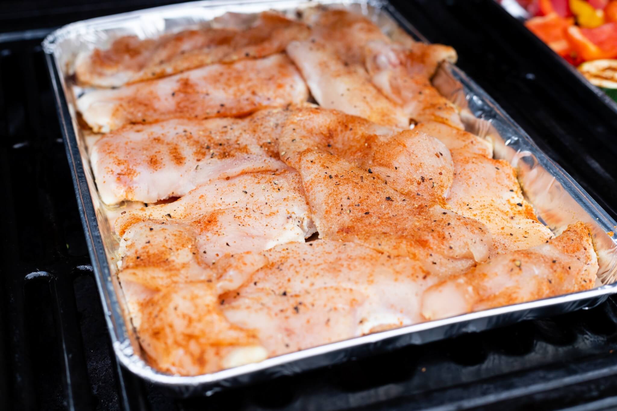 Chicken breasts prepared for cooking in the oven