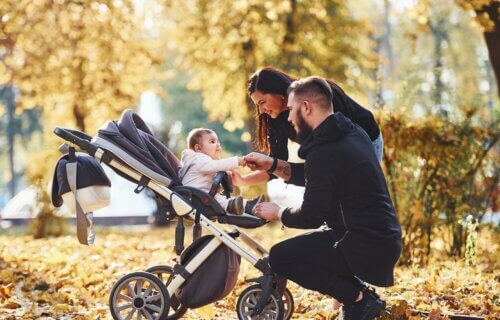 Couple with baby in stroller outside