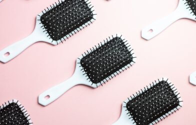 Hair brushes on a pink background