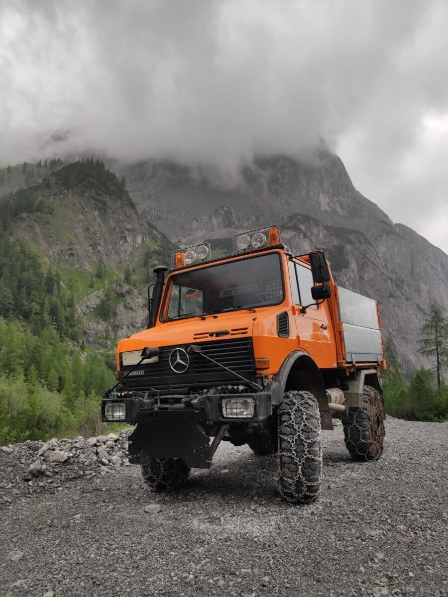 Mercedes Unimog truck in front of a mountain