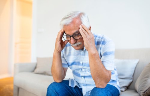 Older man battling stress, cognitive decline or headache