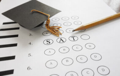 SAT college admission test with pencil and mortarboard