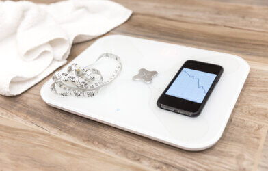 Smart scale with measuring tape and a smartphone for weight loss management