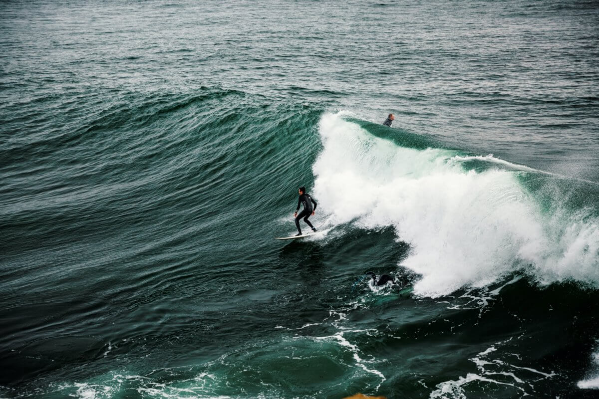 Surfer riding waves off Santa Cruz