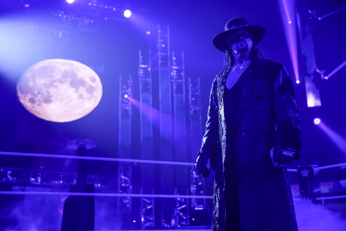 Hall of Famer The Undertaker stands in a WWE ring. 