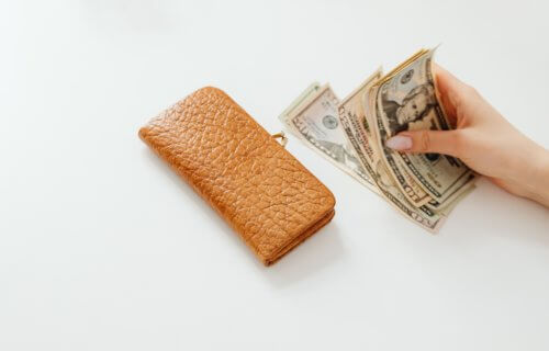 Woman putting money into a wallet