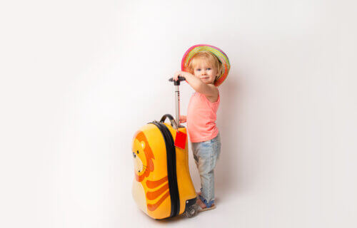 Young child holding luggage