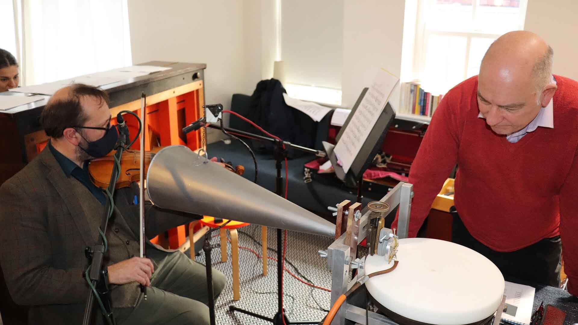 Musicians playing music into old recording equipment. 