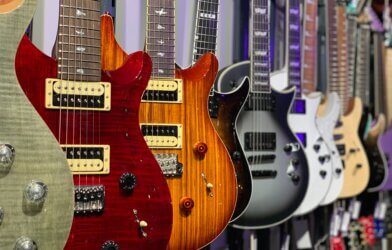 A row of electric guitars at a store