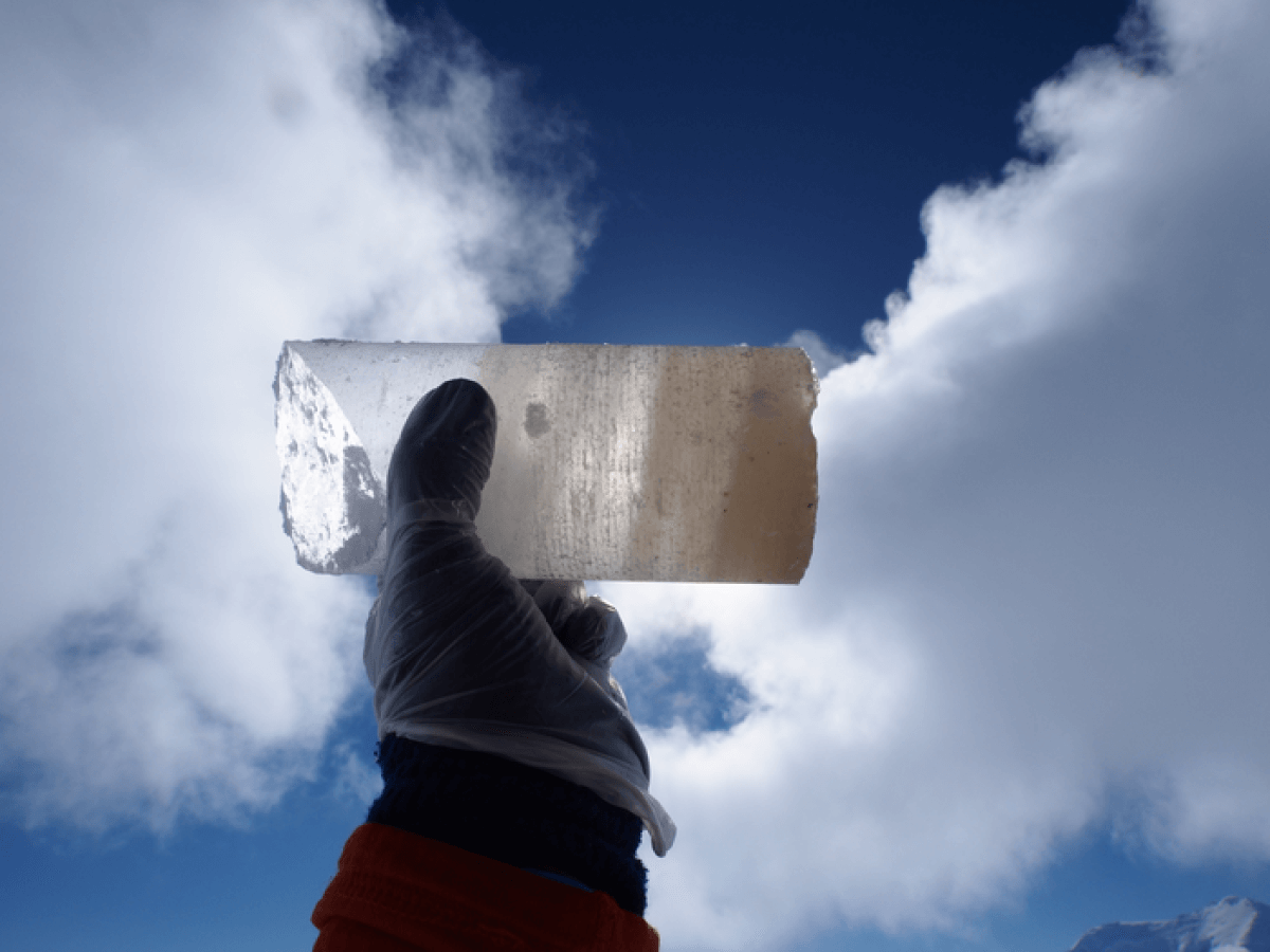 Scientist holds an ice core sample.