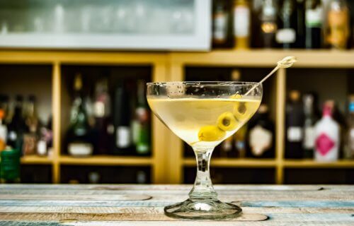 a dirty martini sitting on a bar