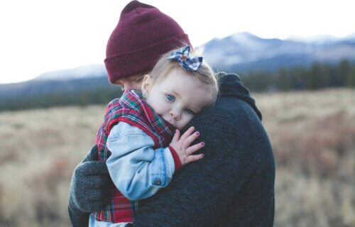Father hugging child outdoors