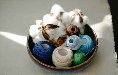 A bowl of cotton plants and fabric