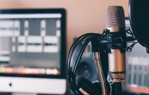 Podcast recording setup with microphone and computer