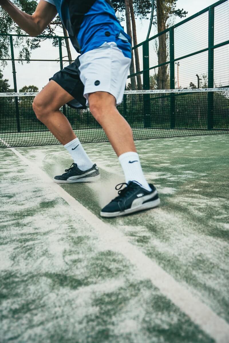 Close-up Photo of Man Standing on Tennis Court wearing Nike Socks