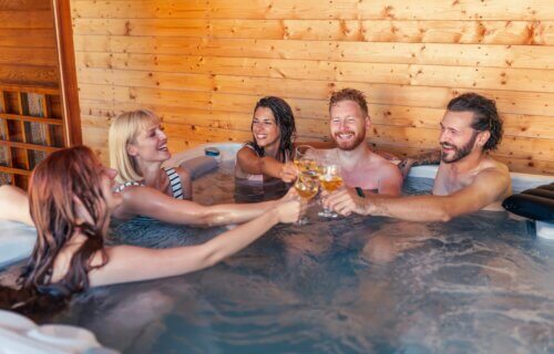 Group of friends toasting in a hot tub jacuzzi