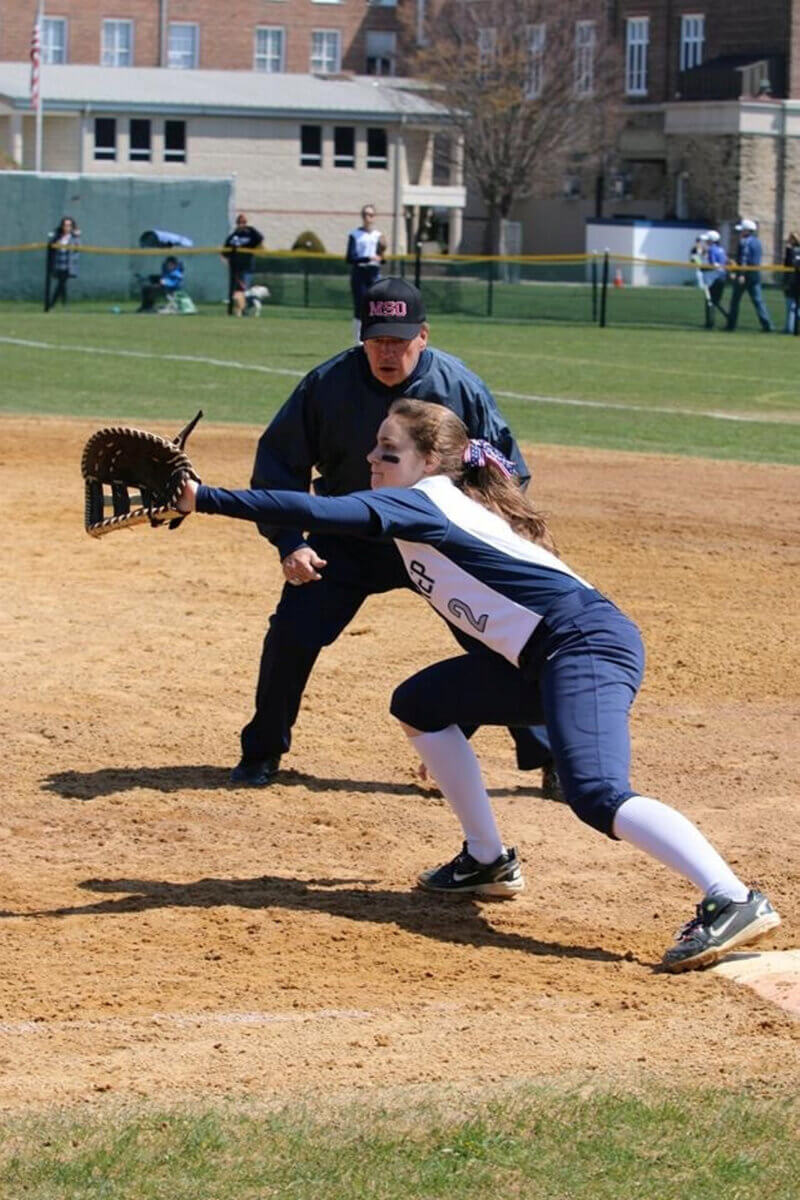 Lily Seibert playing softball in college.